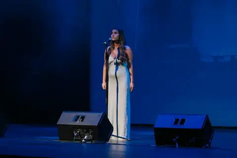 A singer performing on the SunPAC stage during an AFIN Awards Night.