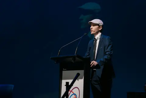 An award presenter at the SunPAC podium during the AFIN ceremony.